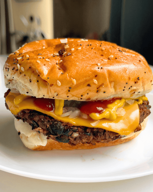 black bean burger with a sesame bun on a white plate