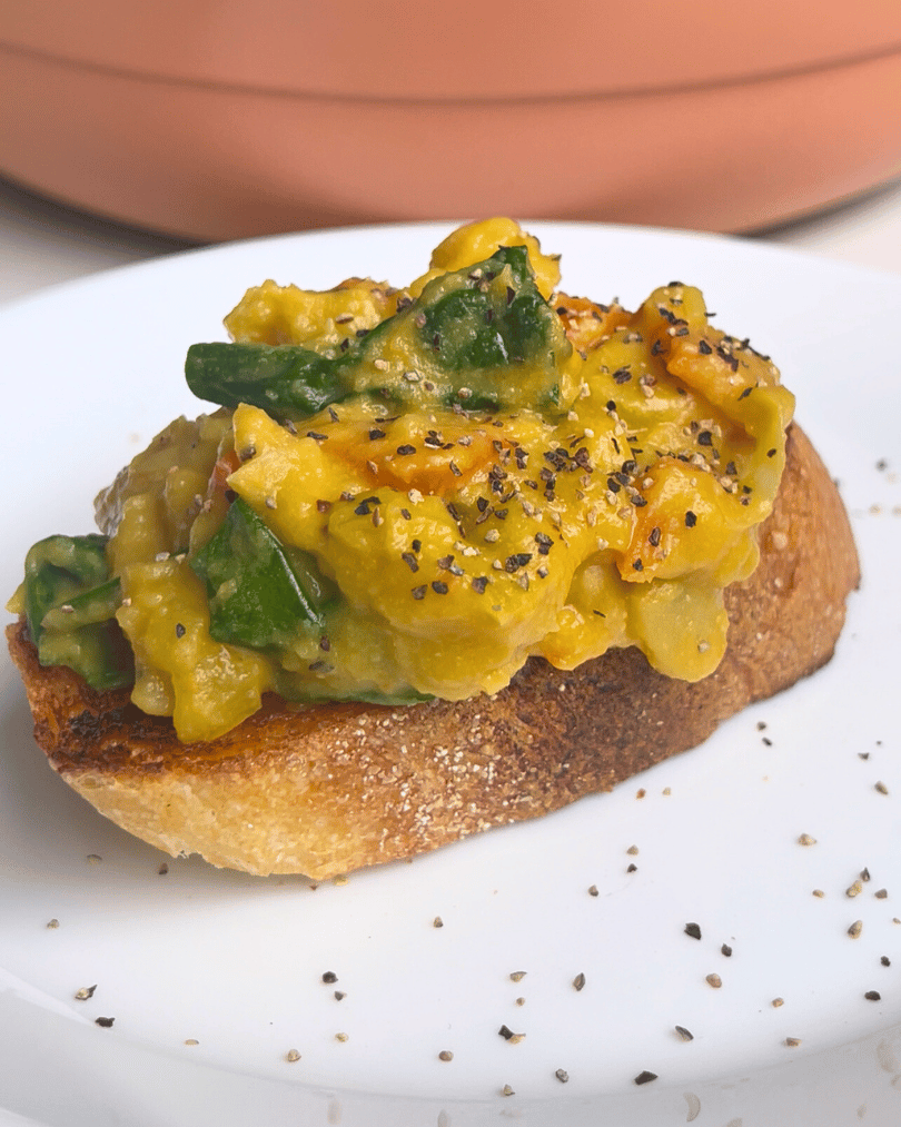 Creamy butter beans on toast, served on a white plate with black pepper.