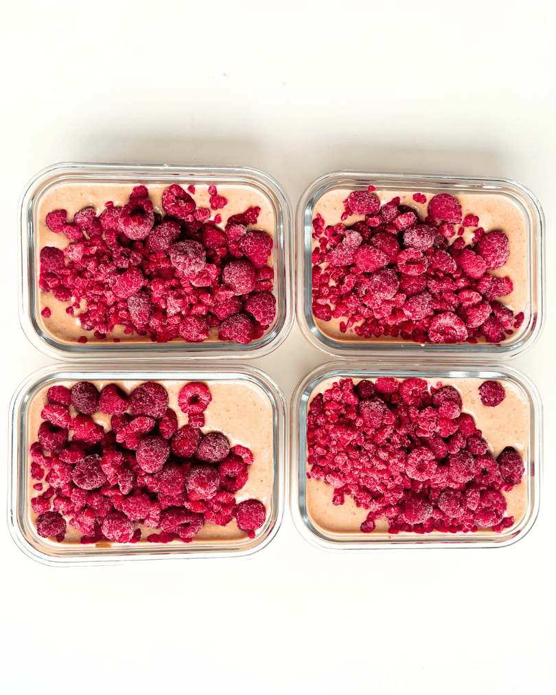 chocolate protein overnight oats with raspberries in meal prep containers