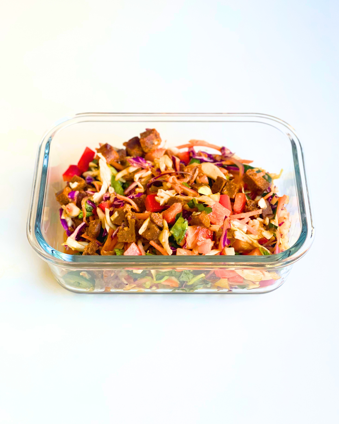 thai crunch salad with ginger dressing in a meal prep container