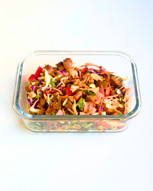 thai crunch salad with ginger dressing in a meal prep container