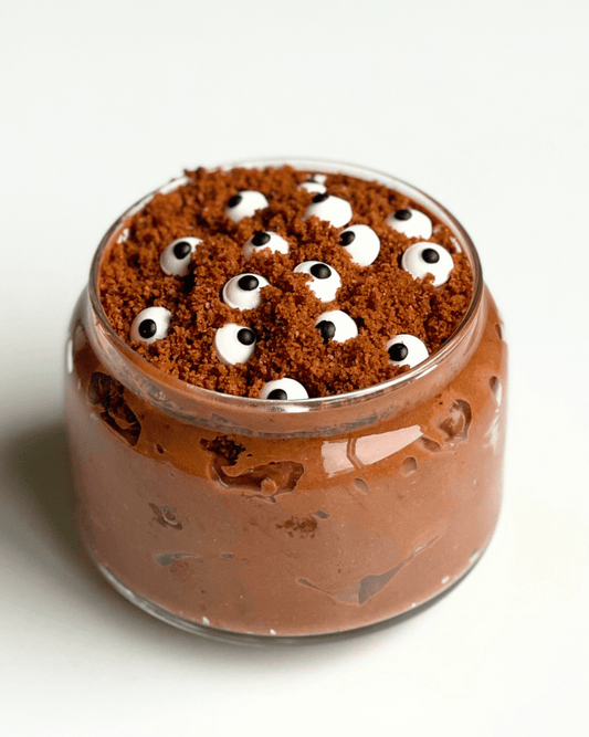 vegan dirt cake in a glass jar with a white background