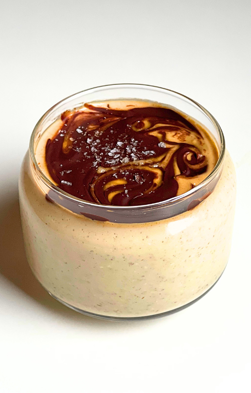 Overnight oats in a glass jar on a white background
