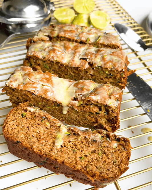 zucchini bread with key lime glaze sliced into four pieces