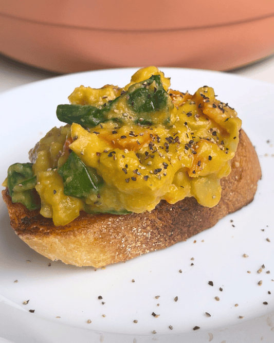 Creamy butter beans on toast, served on a white plate with black pepper.