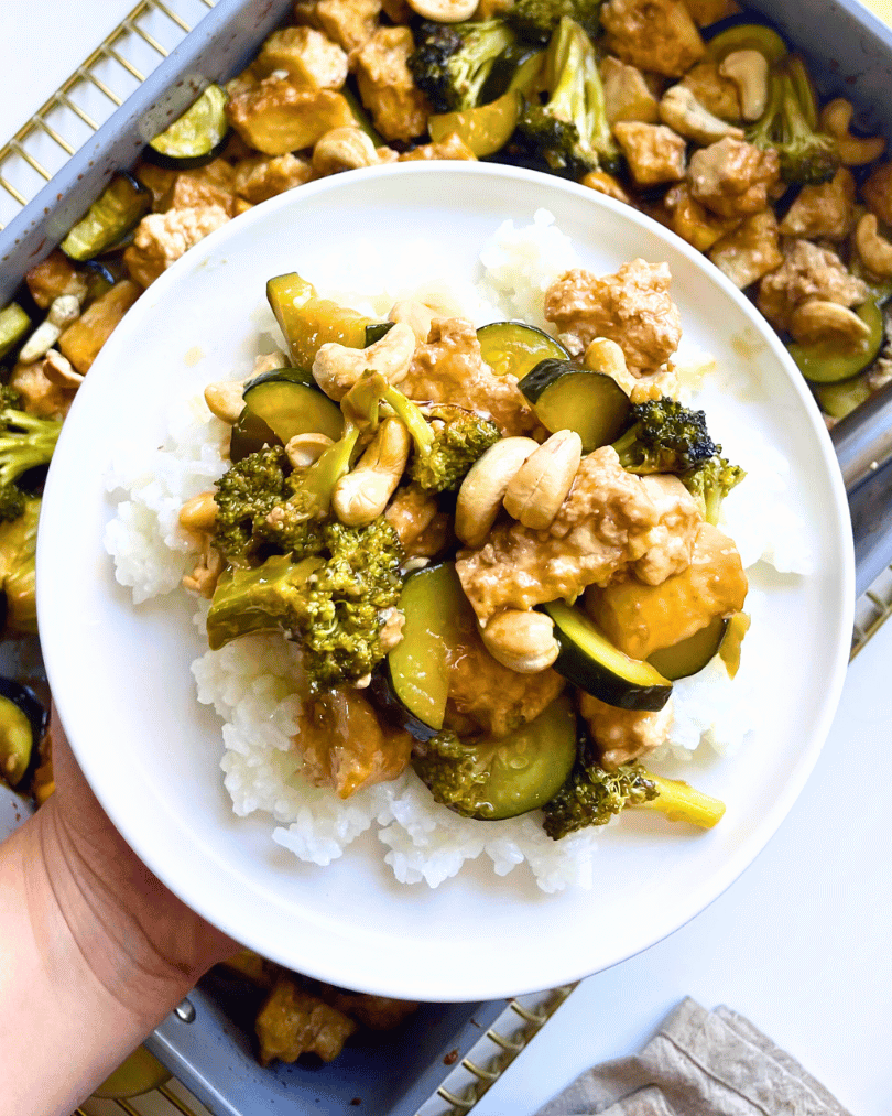 cashew tofu recipe on white rice on a white plate