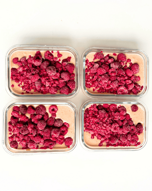 chocolate protein overnight oats with raspberries in meal prep containers