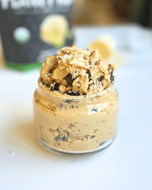 dible cookie dough in a glass jar and a protein powder bag in the background