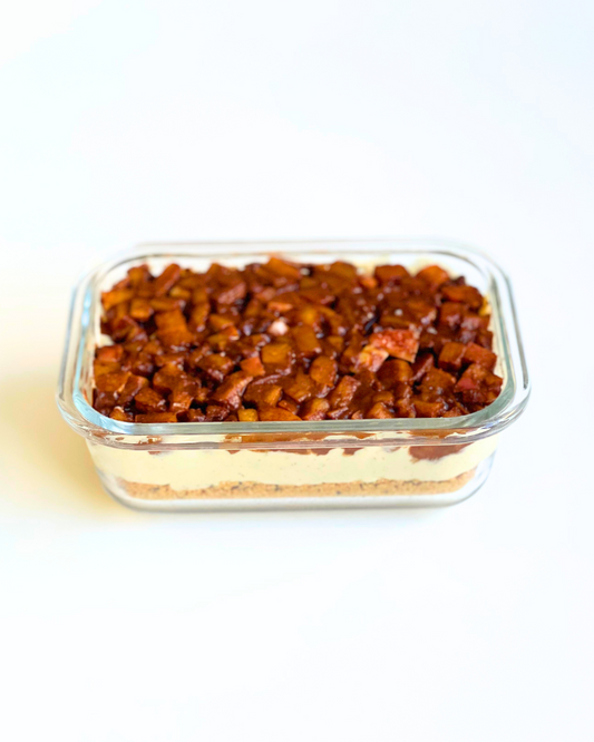 Apple Pie Protein Yogurt Bowl in a glass meal prep container on a white surface