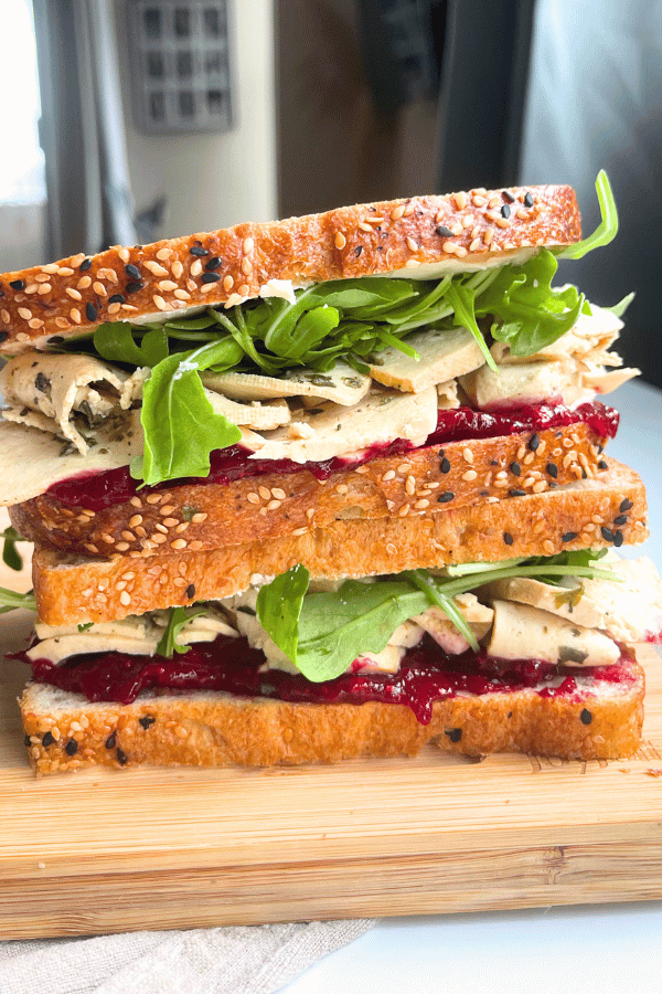 high protein vegan meal prep turkey cranberry sandwich stacked on top of eachother