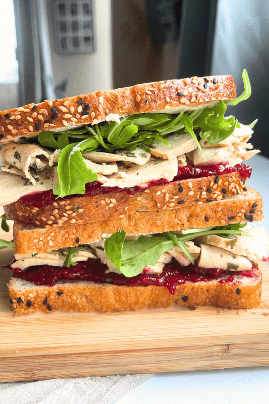 high protein vegan meal prep turkey cranberry sandwich stacked on top of eachother