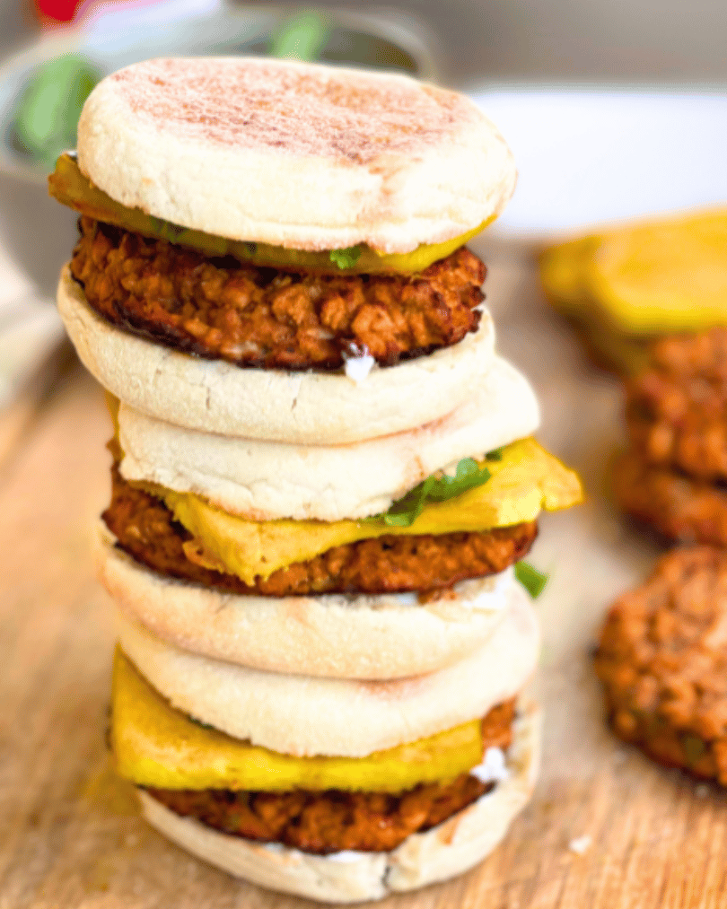 vegan sausage and egg breakfast sandwiches stacked on top of one another