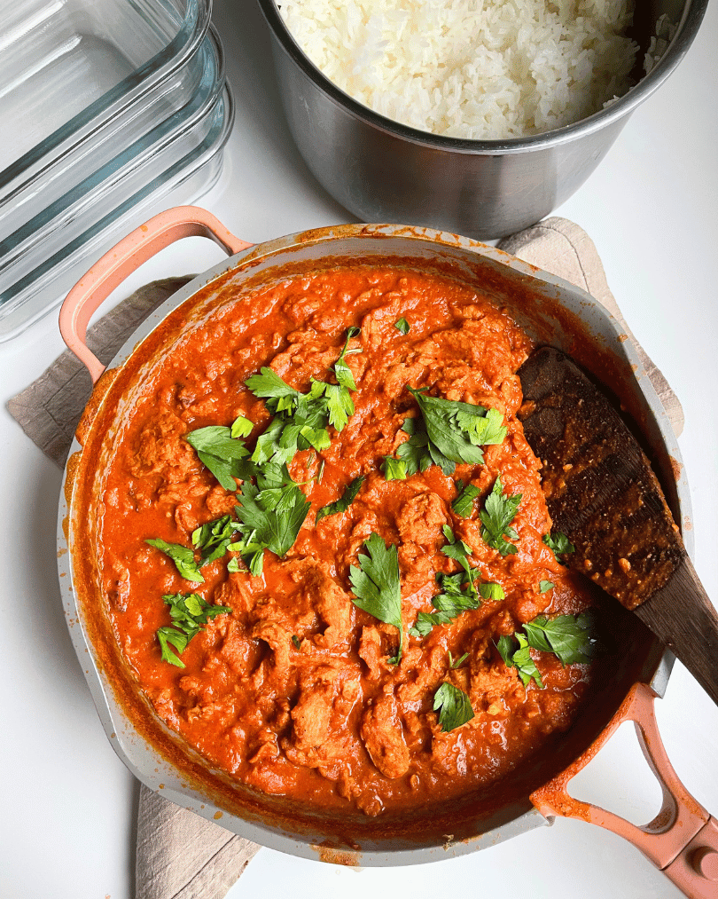 tofu tikka masala in a grey pot with pink handles on a white counter