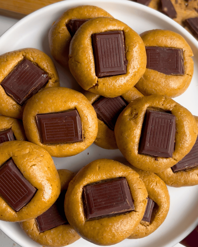 no-bake peanut blossom cookies on a white plate held up close