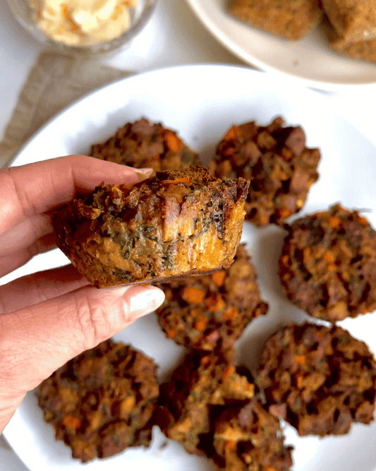 vegan thanksgiving stuffing muffins, with one being held by a hand up close