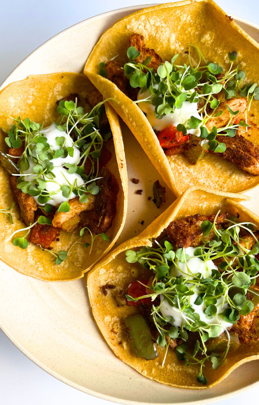 3 vegan tacos in a white plate on a white background